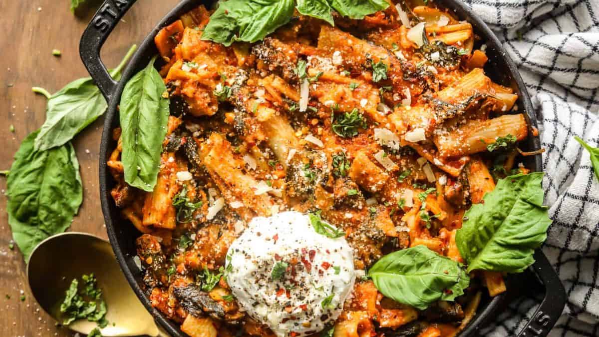 One Pot Creamy Tomato Pasta with Spinach in a cast iron. 