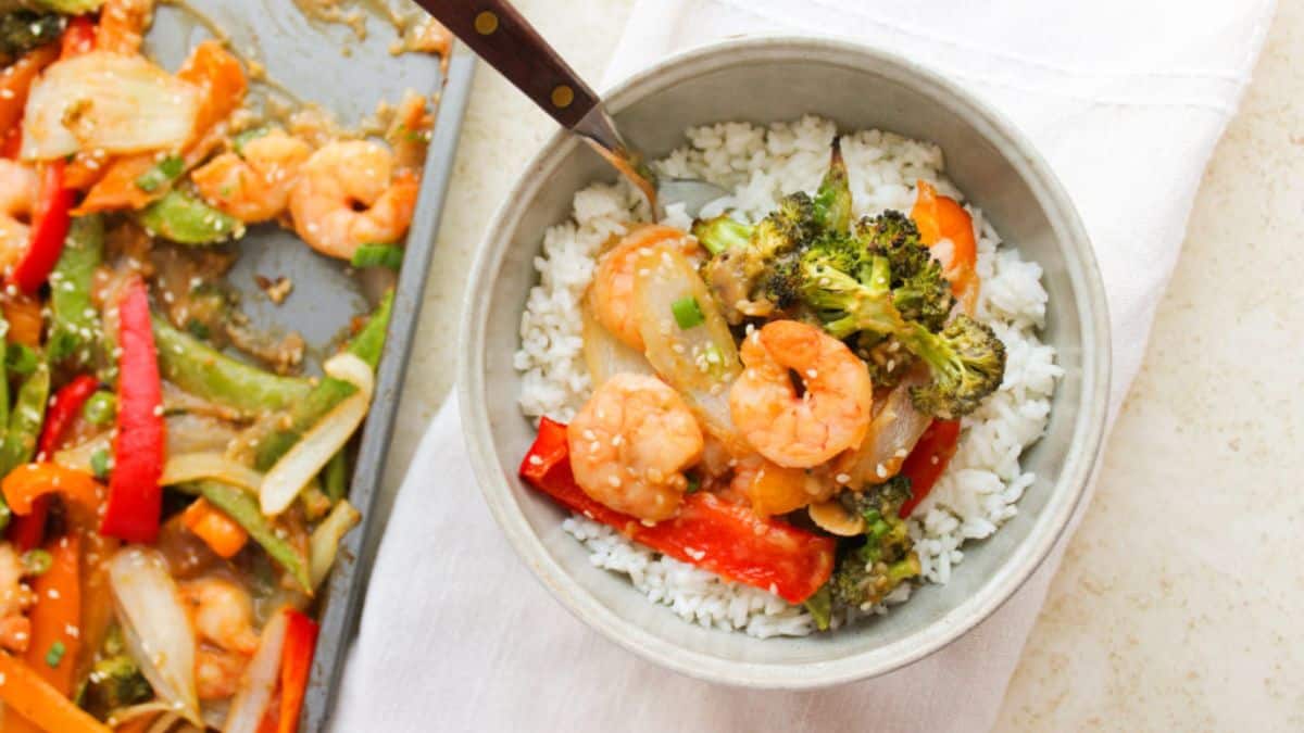 Shrimp and Vegetable Stir Fry served over a bowl of rice. 