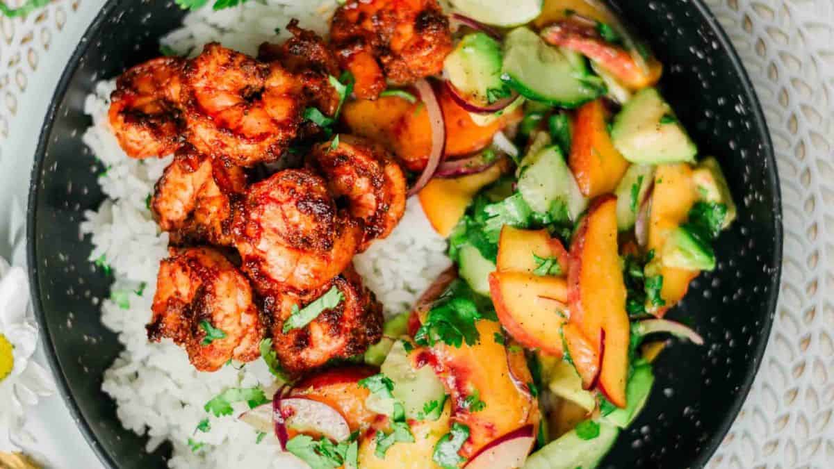 A serving of Spicy Shrimp Bowl Recipe with Rice and Peach Avocado Salad