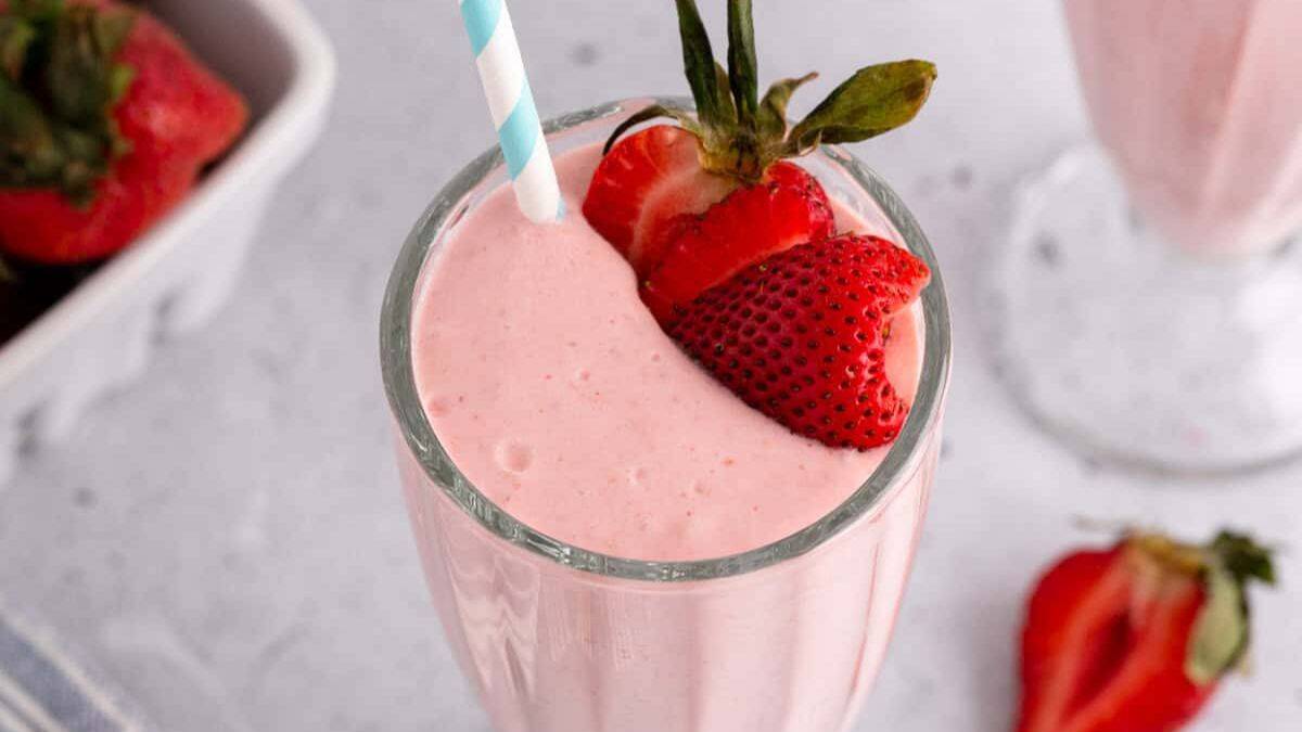 A glass of strawberry milk shake with coconut milk.