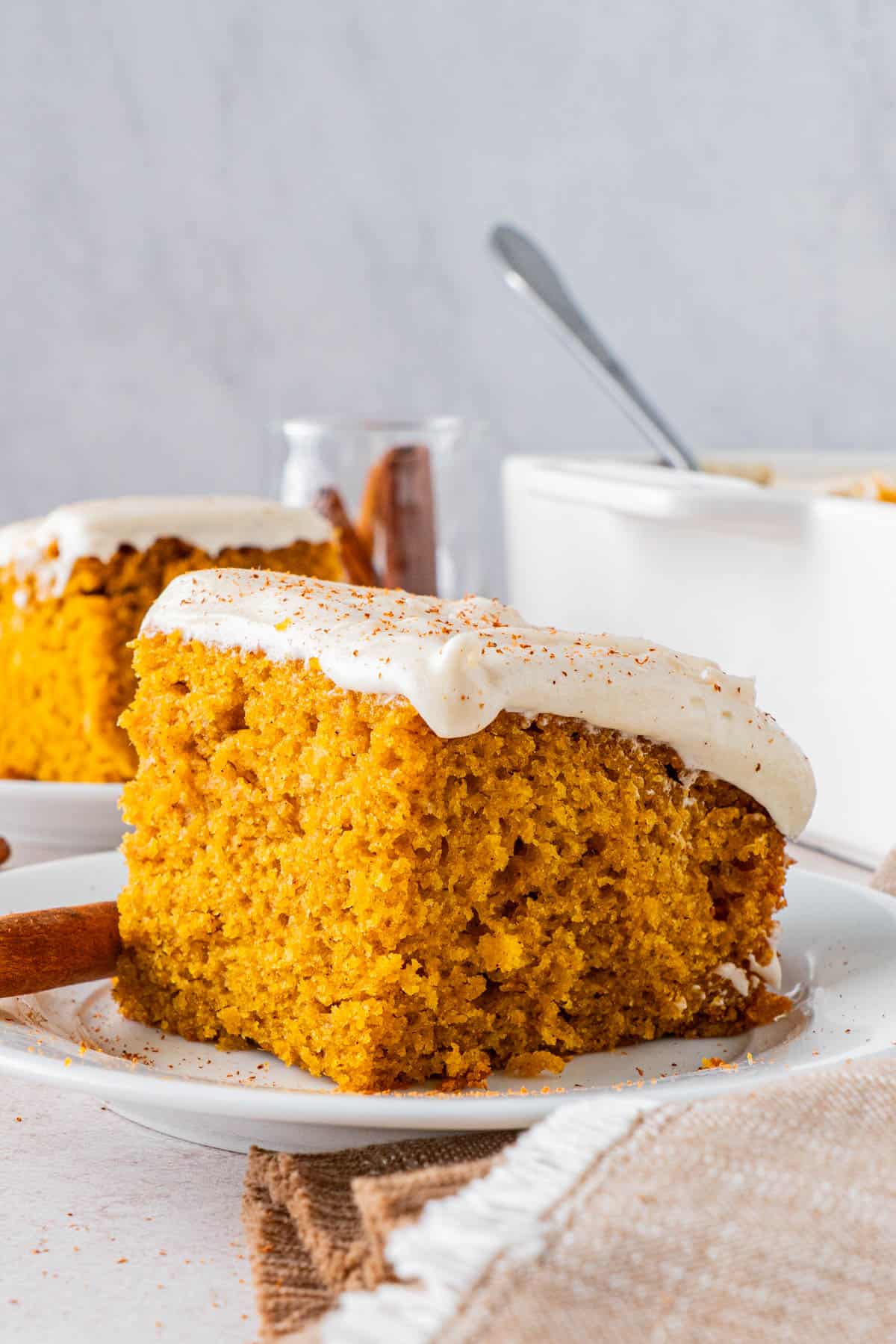 A slice of Moist Pumpkin Cake with Cream Cheese Frosting