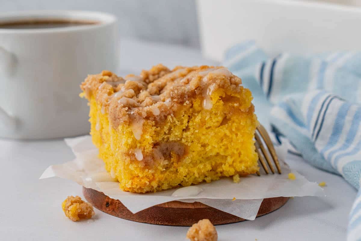 A single serving of Cake Mix Coffee Cake with a fork and a mug with coffee on the side. 