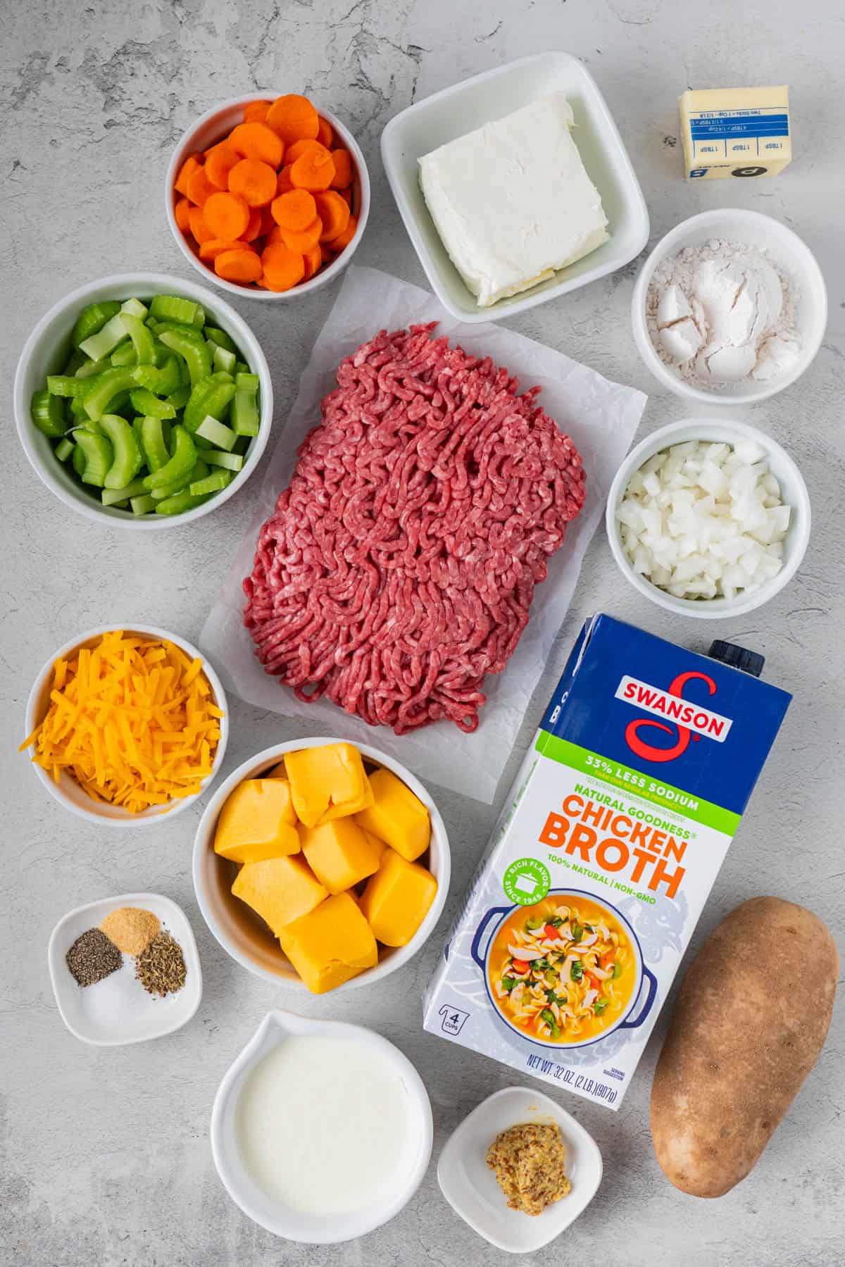 Ingredients for Stovetop Cheeseburger Soup with Velveeta: Carrots, Celery, Cheddar Cheese, Velveeta Cheese, Butter, Chicken Broth, Ground Meat, Onion, All purpose flour, Spices, Potato, Heavy Cream, Cream Cheese, Dijon Mustard.
