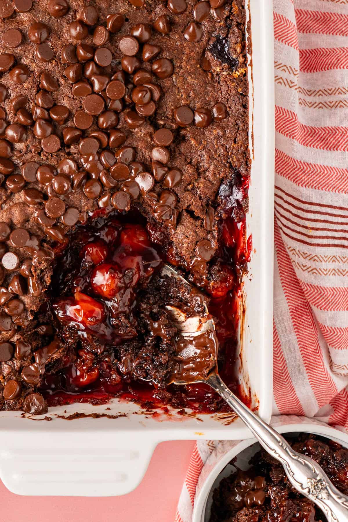 Chocolate Cherry Dump Cake with a serving spoon with visible cherries on it.