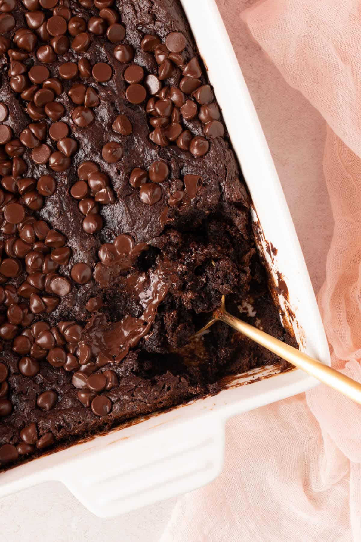 Chocolate Dump Cake With Pudding with the corner taken out and a spoonful of it.