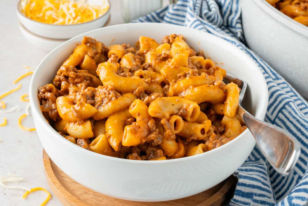 A single served in a white bowl Homemade Cheesy Hamburger Helper.