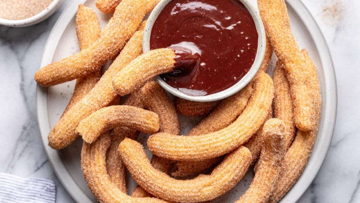A serving of Churros with chocolate dip.
