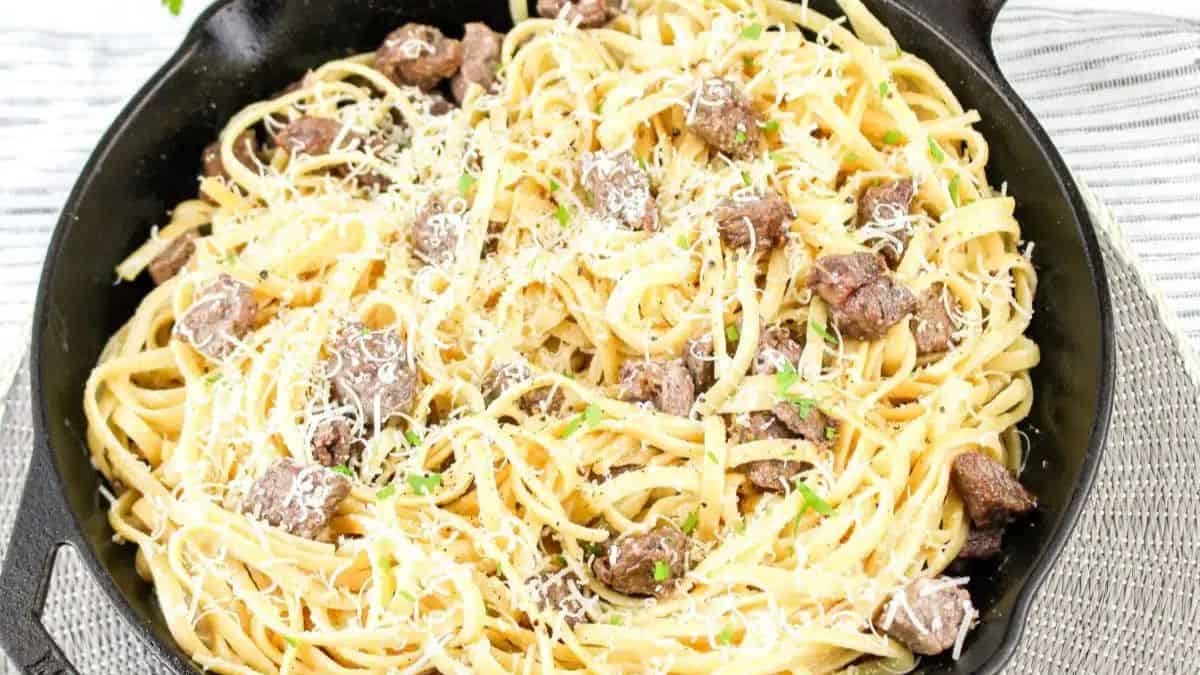 Creamy Steak Fettuccine on a cast iron. 
