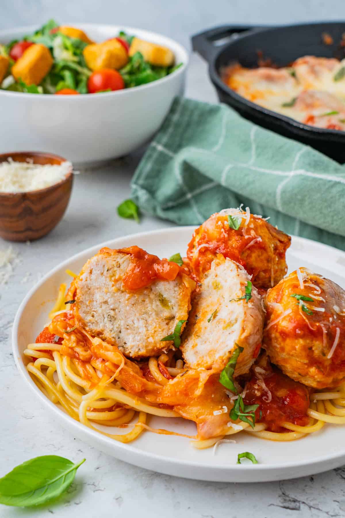 Cheesy Chicken and Rice Casserole Meatballs, served over pasta in a plate.