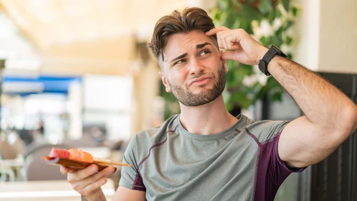 confused man holding sushi