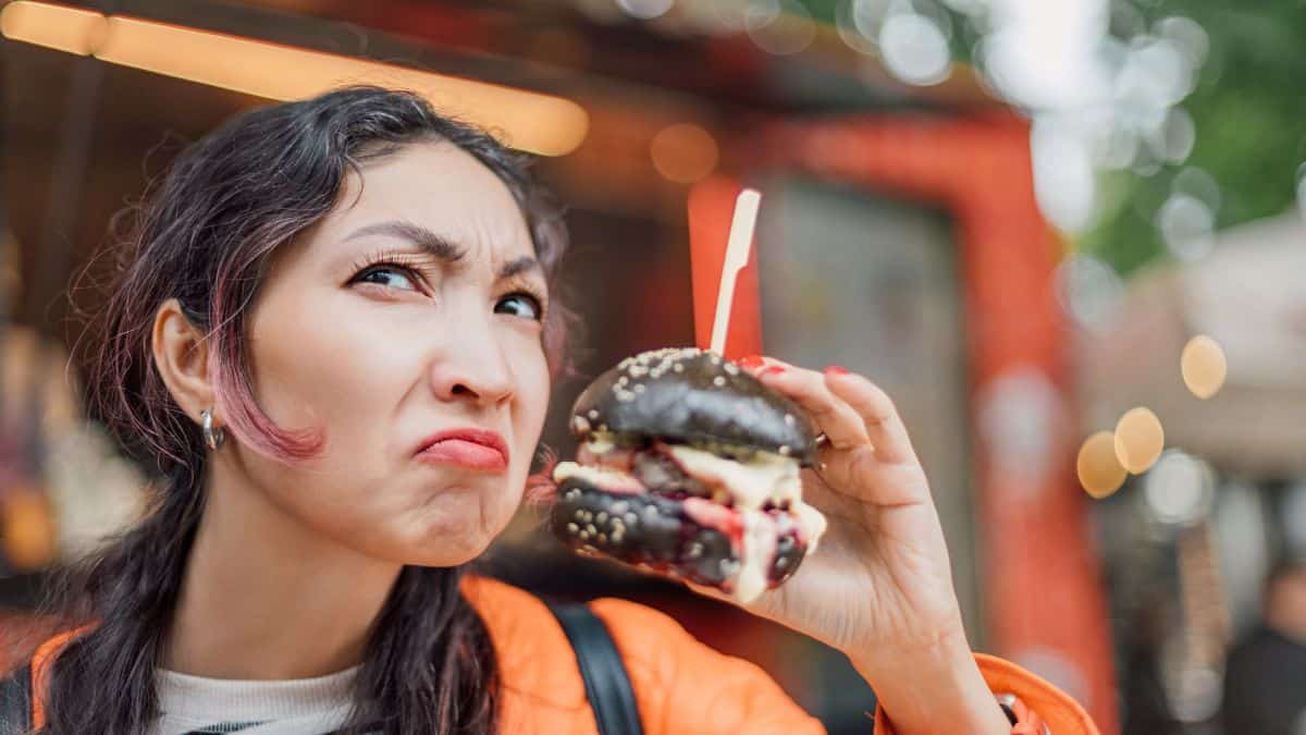 confused woman with burger