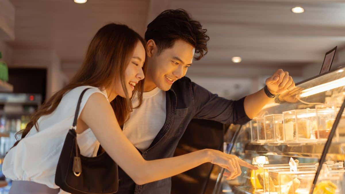 couple looking at bakery case