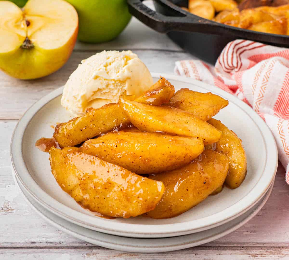 A serving of Southern Fried Apples with a scoop of vanilla ice cream