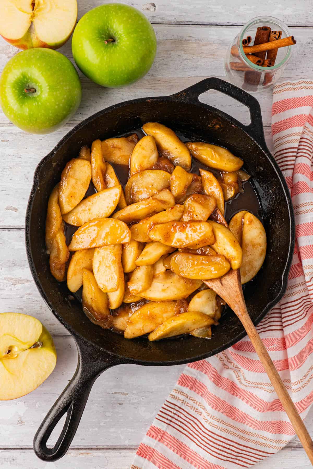 Southern Fried Apples on a skillet with wooden spoon