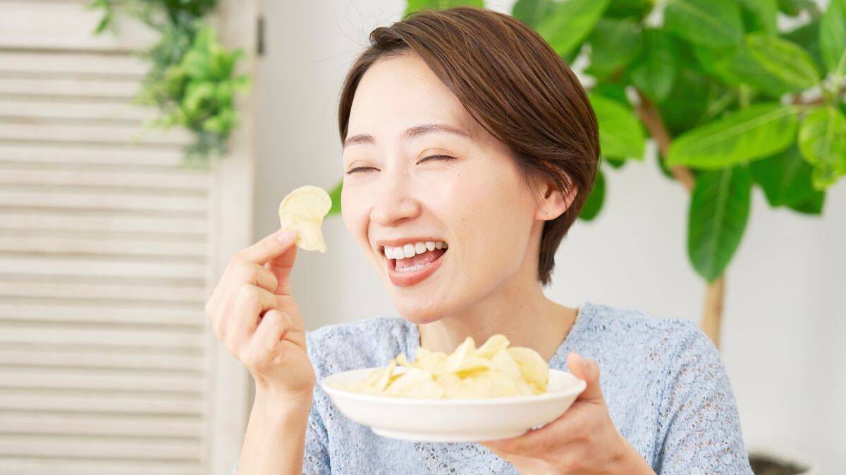 happy woman eating chips