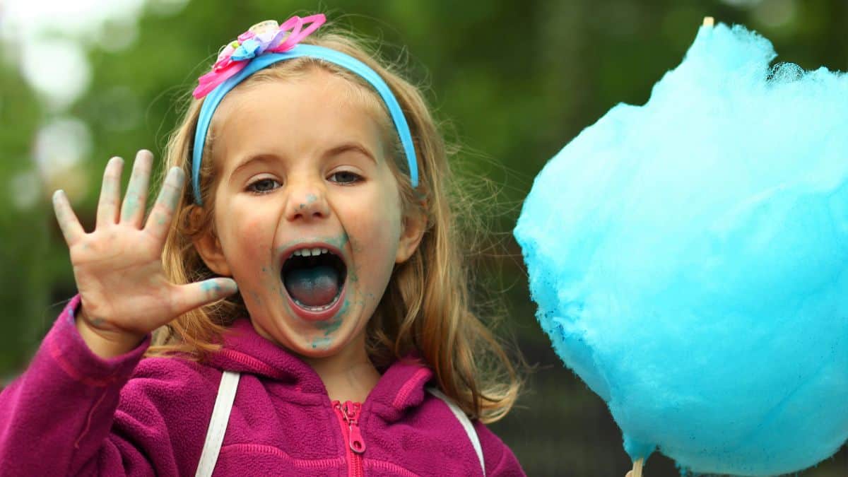 little girl eating cotton candy