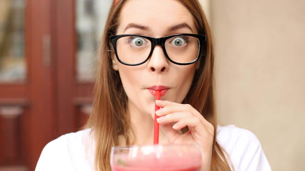 surprised woman drinking a smoothie milkshake