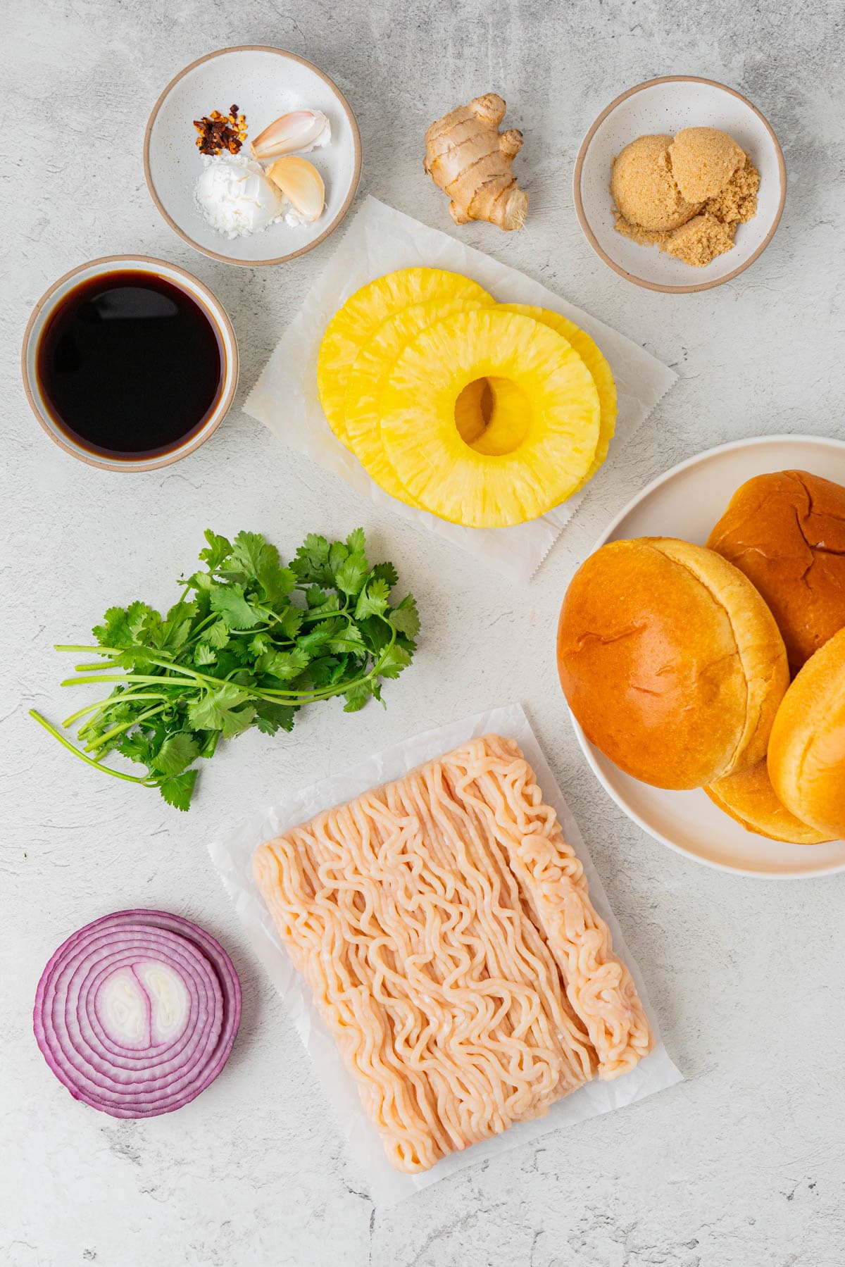 Ingredients for Teriyaki Chicken Burgers With Grilled Pineapple: Ginger, Sugar, Spices, Pineapple slices, buns, cilantro, onions, ground chicken, 