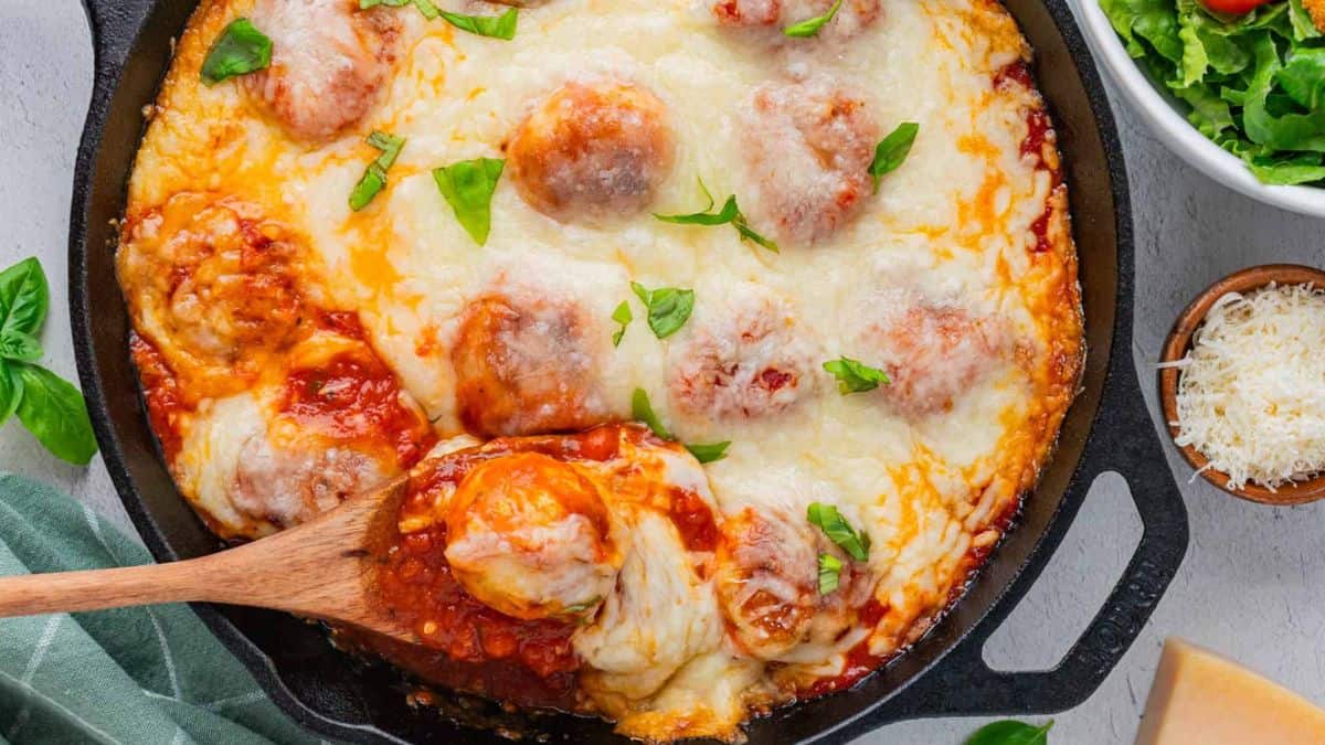 Baked Cheesy Chicken Parmesan Meatballs in a cast iron.