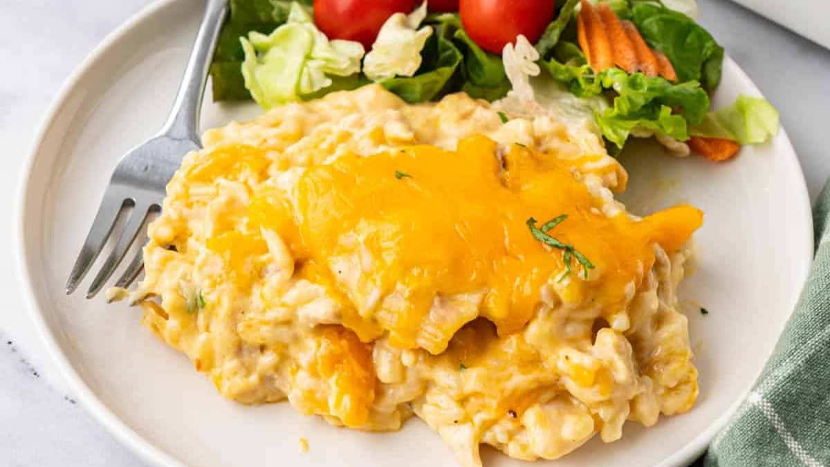 A serving of Cheesy Chicken and Rice Casserole with side salad.