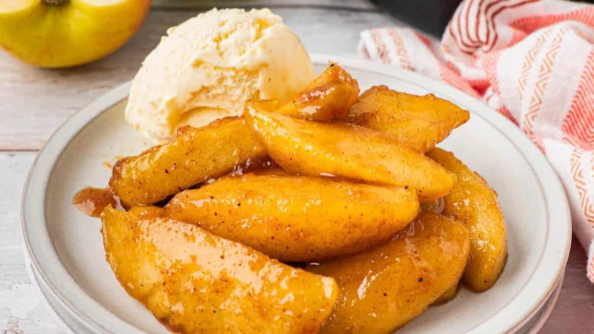 A serving of Southern Fried Apples with a scoop of Vanilla Ice Cream.