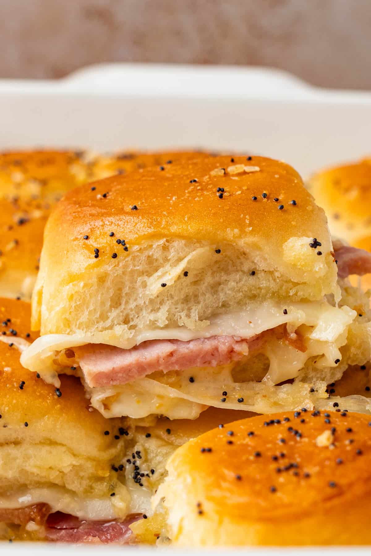 close up slice of Ham And Cheese Sliders on Hawaiian Rolls