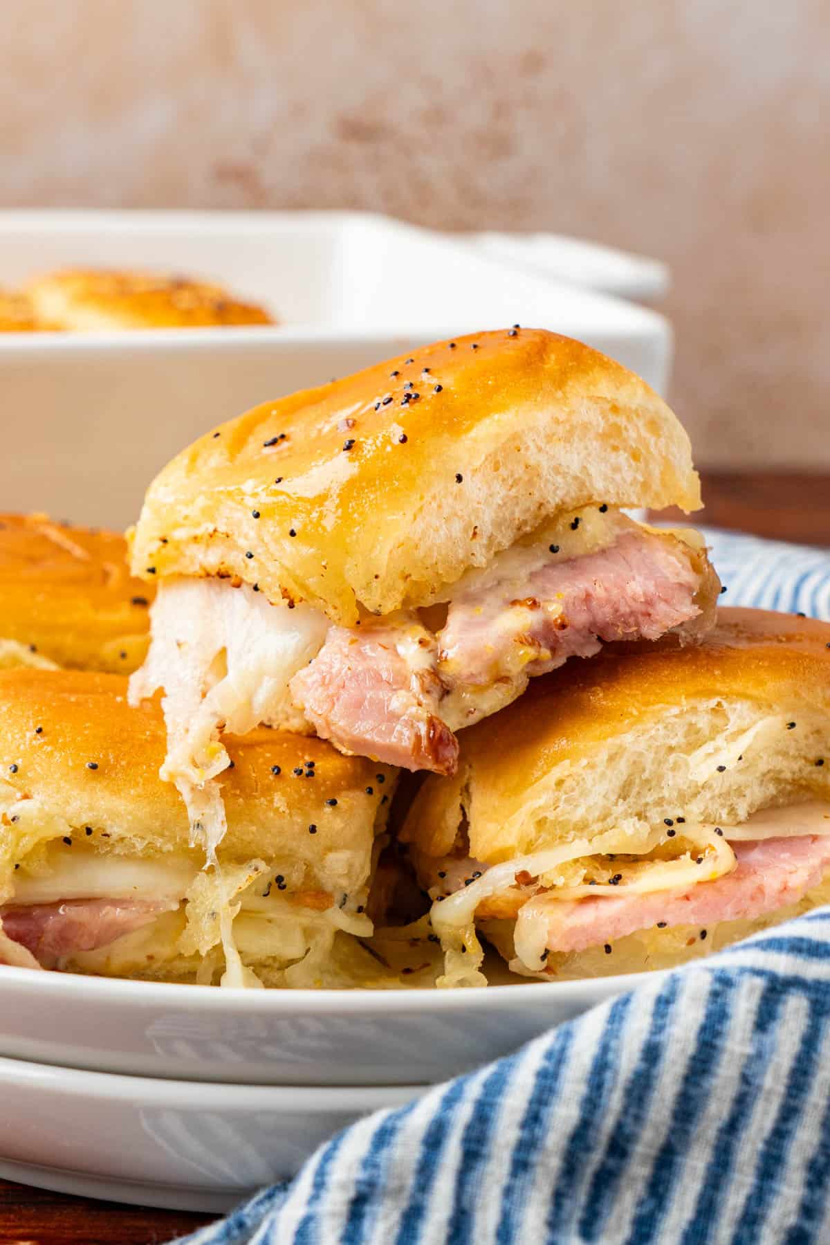 Ham And Cheese Sliders on Hawaiian Rolls serve on a white plate.