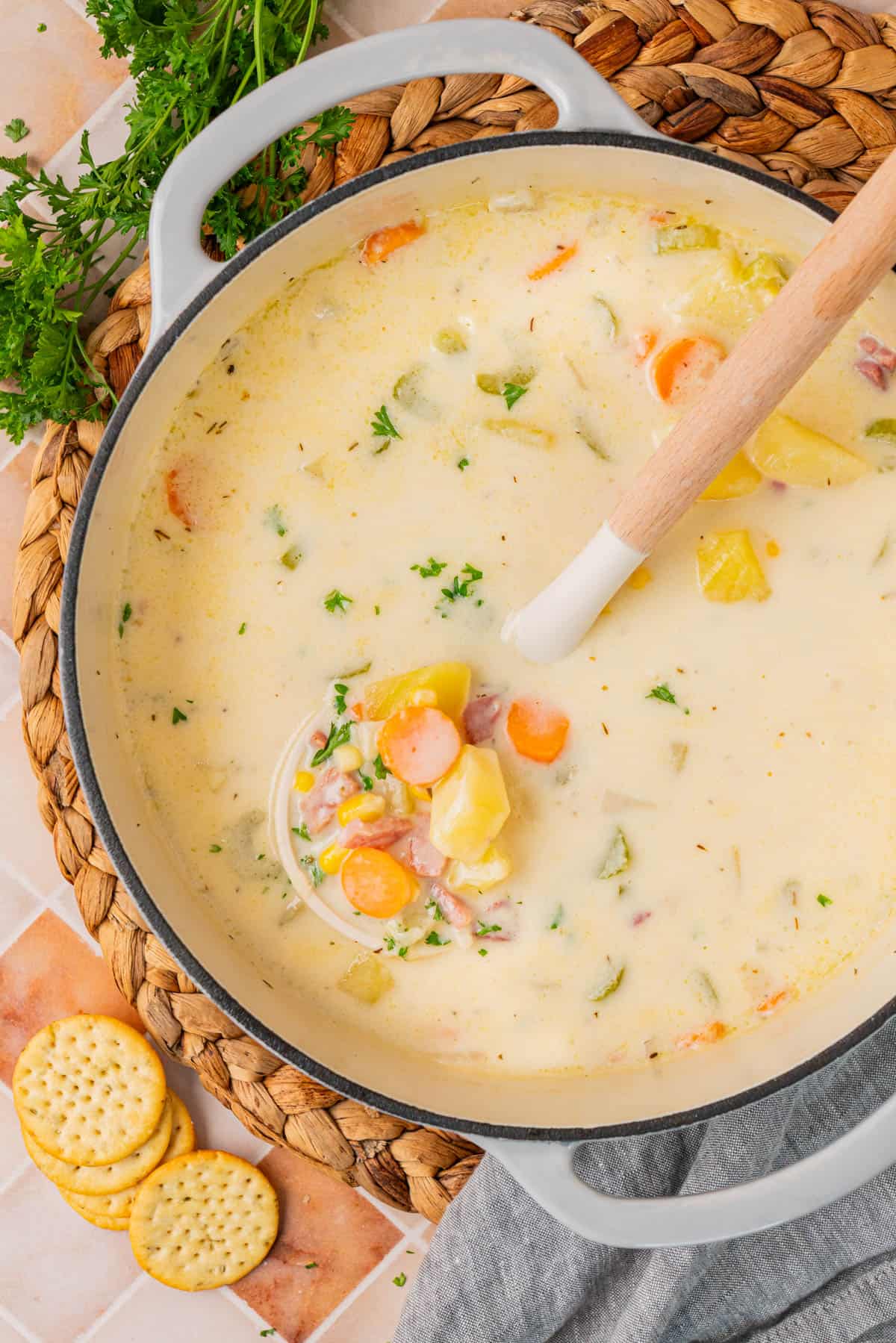 Creamy Ham And Potato Soup in a pot with a ladle.