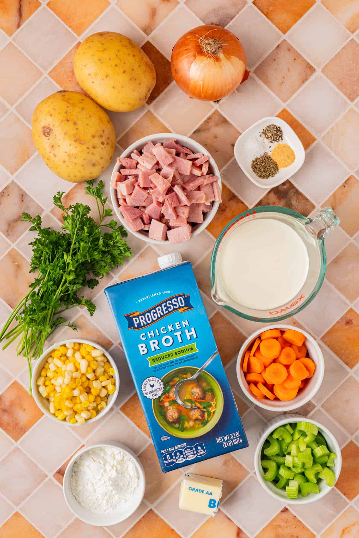 Ingredients for Creamy Ham And Potato Soup: Ham, Potatoes, Onion, Parsley, Heavy Cream, Chicken Broth, Carrots, Celery, Carrots, Flour, Butter.