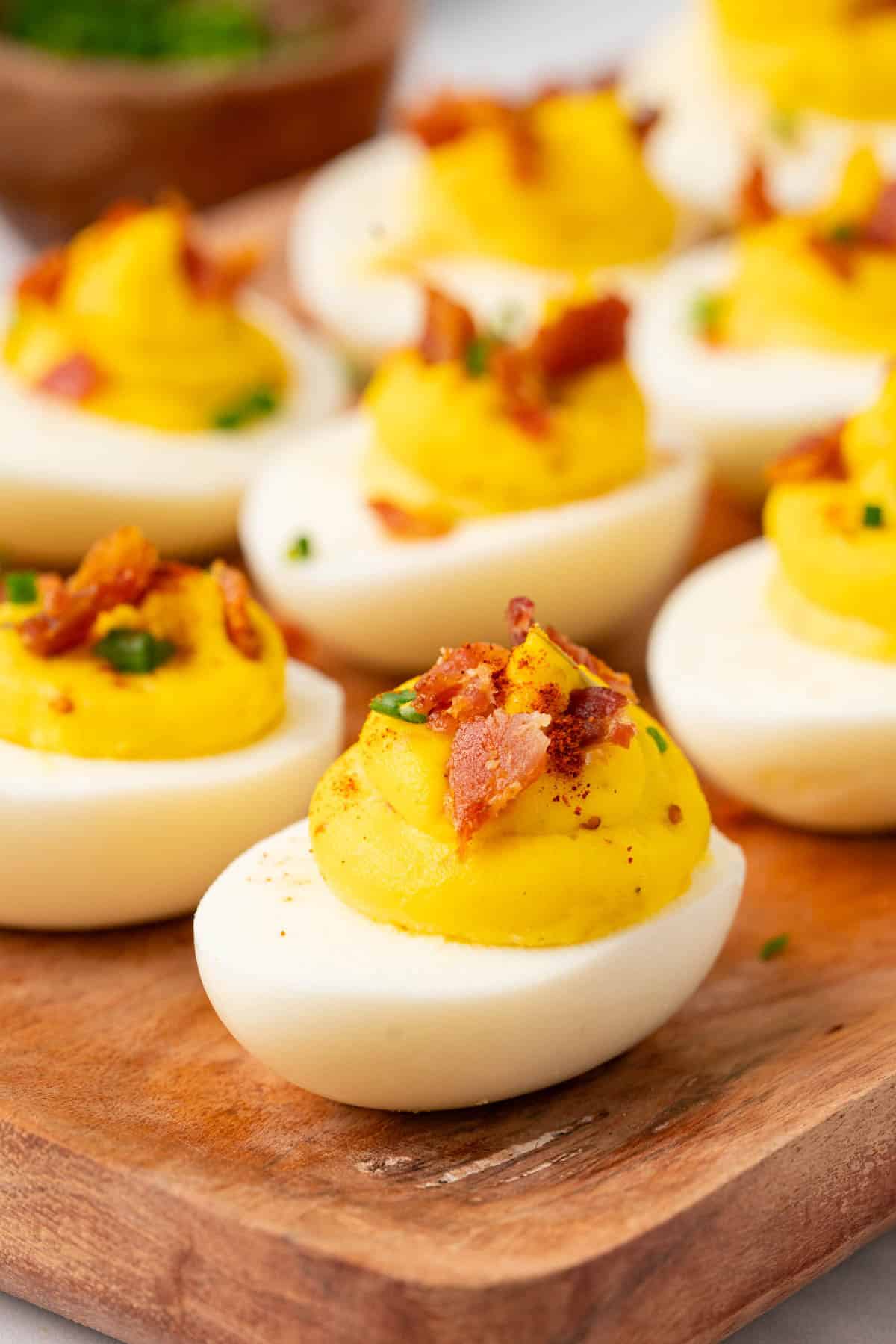 close up shot of deviled eggs with bacon.