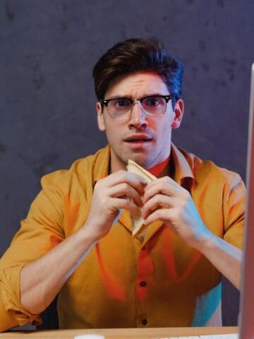confused man at computer with food