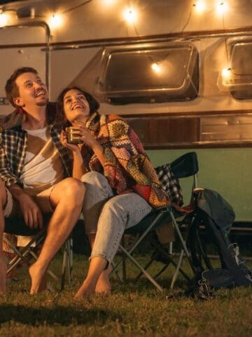 couple camping with fire
