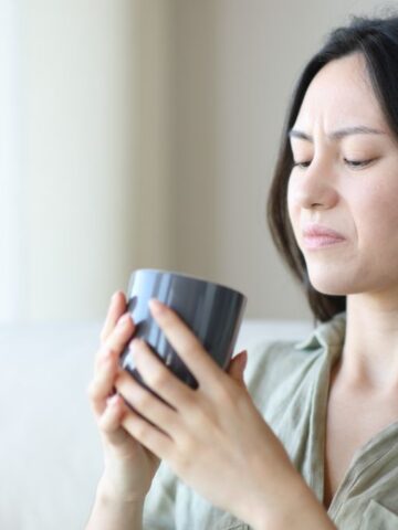 disgusted woman looking at cup