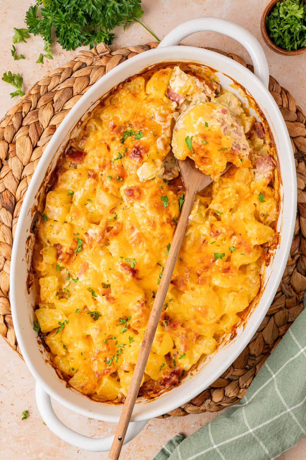 a white casserole dish with a spoonful of the casserole