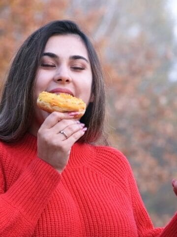 happy woman having a snack outside