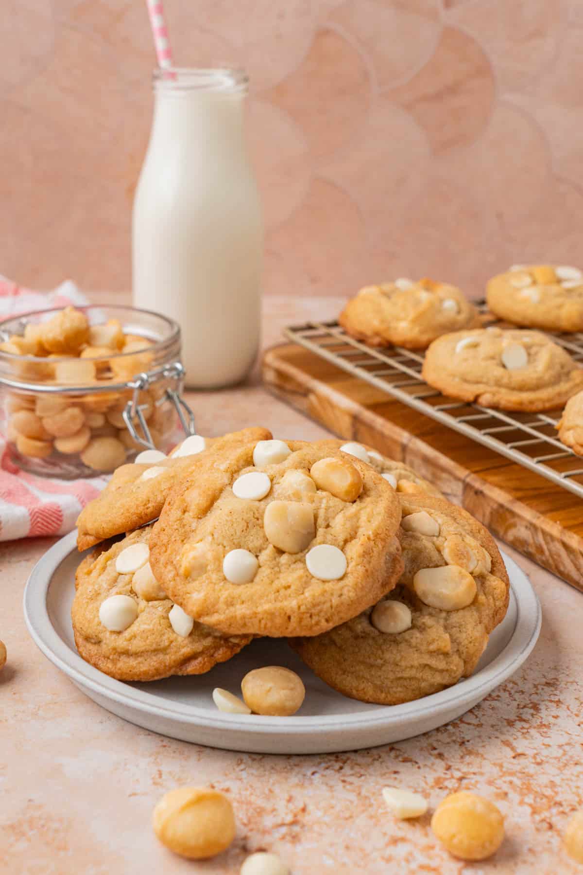 Brown butter macadamia nut cookies, piled high on a plate.