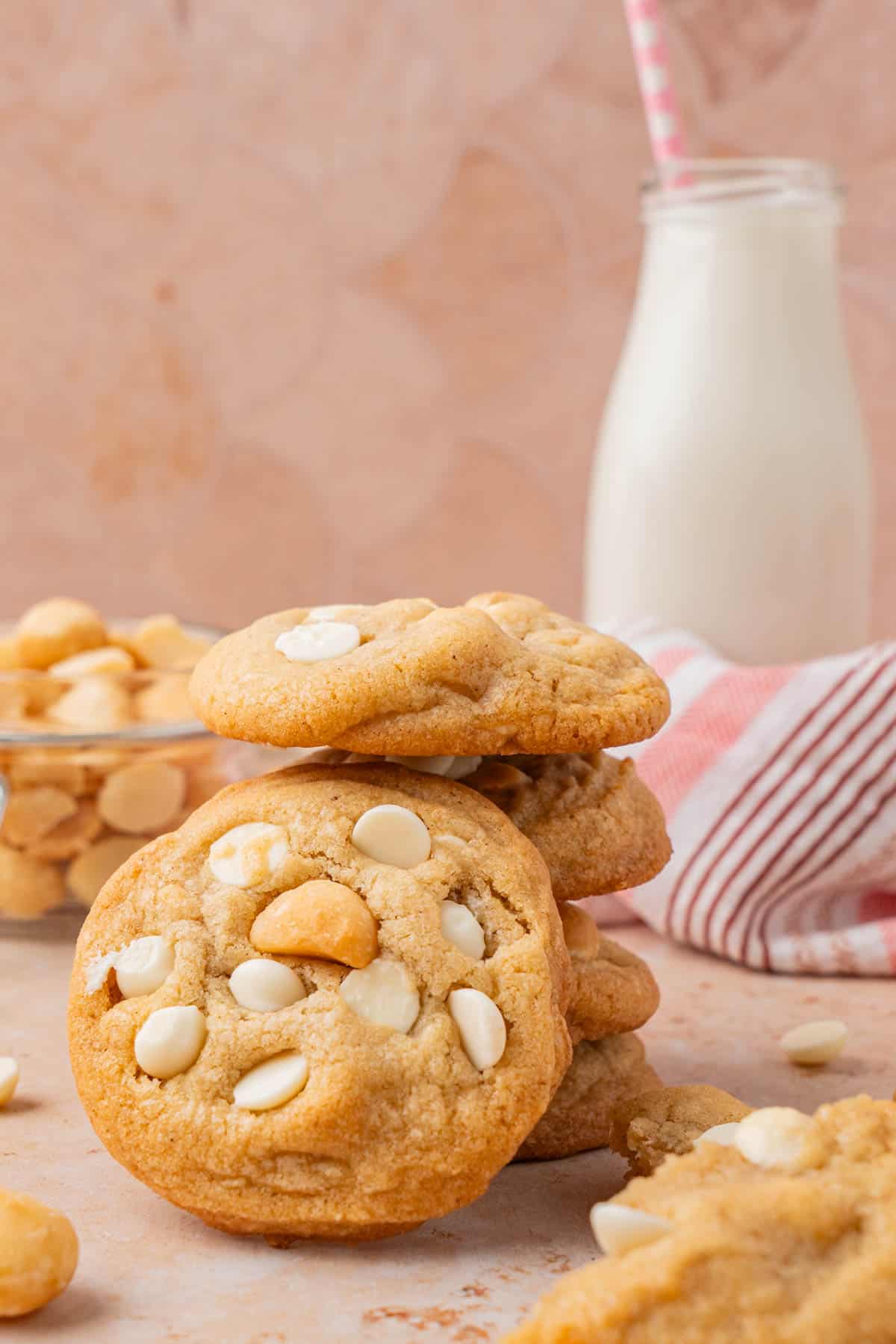 Close up shot of the finished cookies, piled high alongside milk