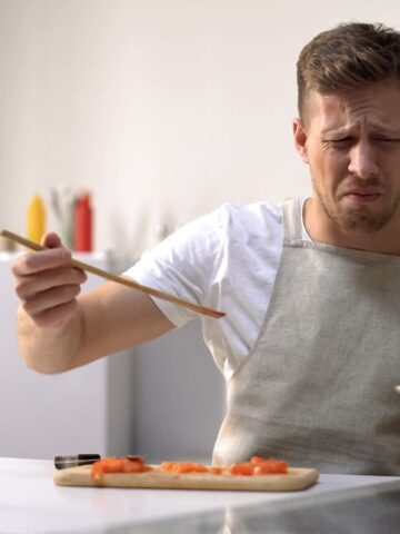 man with disgusted face tasting food