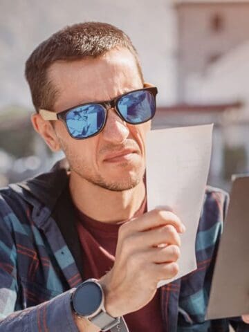 unhappy man looking at food bill