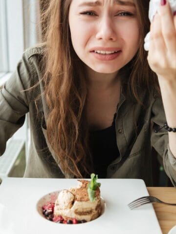woman crying at a coffee shop