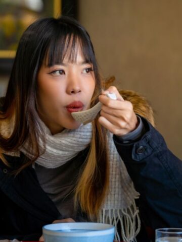 woman drinking soup