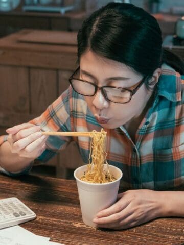 woman eating ramen noodles
