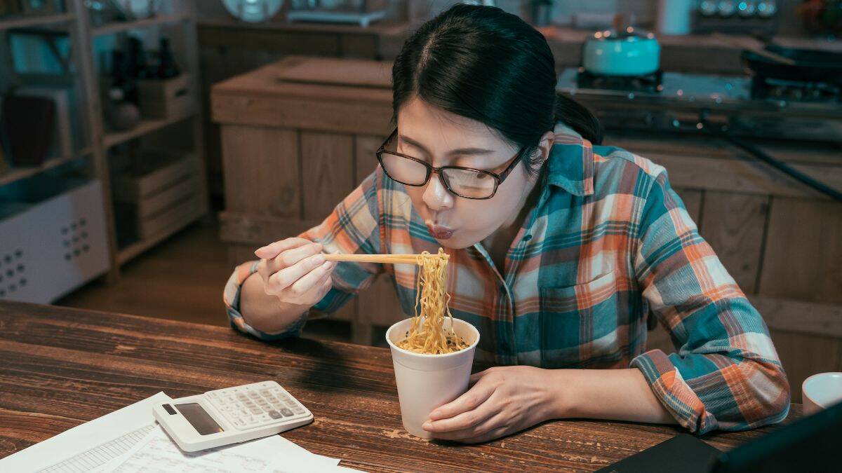 woman eating ramen noodles