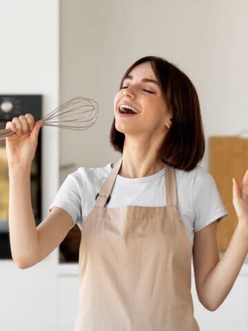 woman singing with whisk