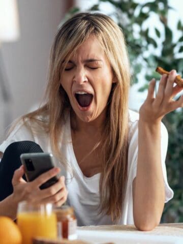 woman yawning with breakfast