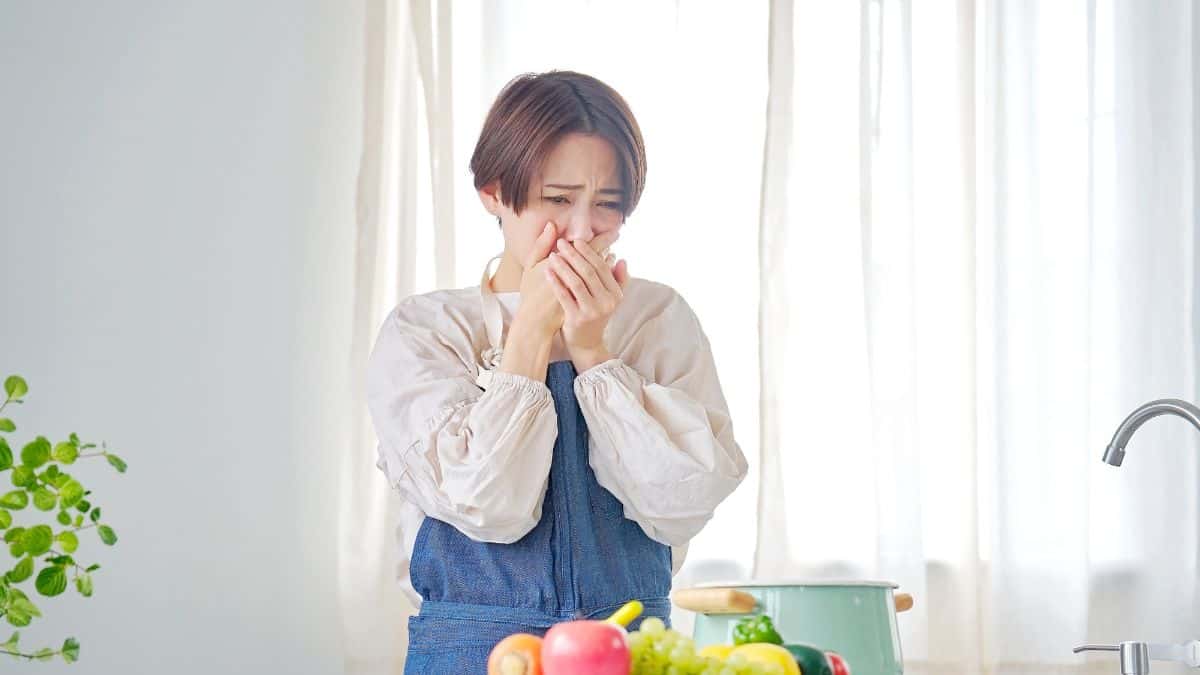 woman looking sick in kitchen
