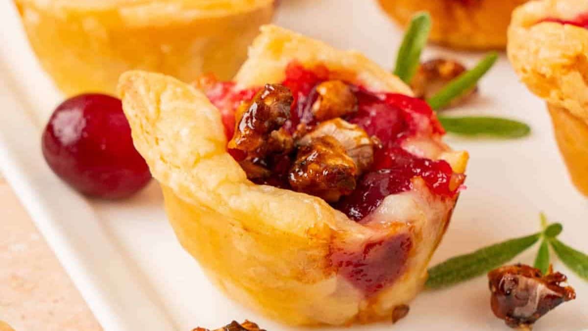 A close up shot of Cranberry Brie Bites served on a white plate. 