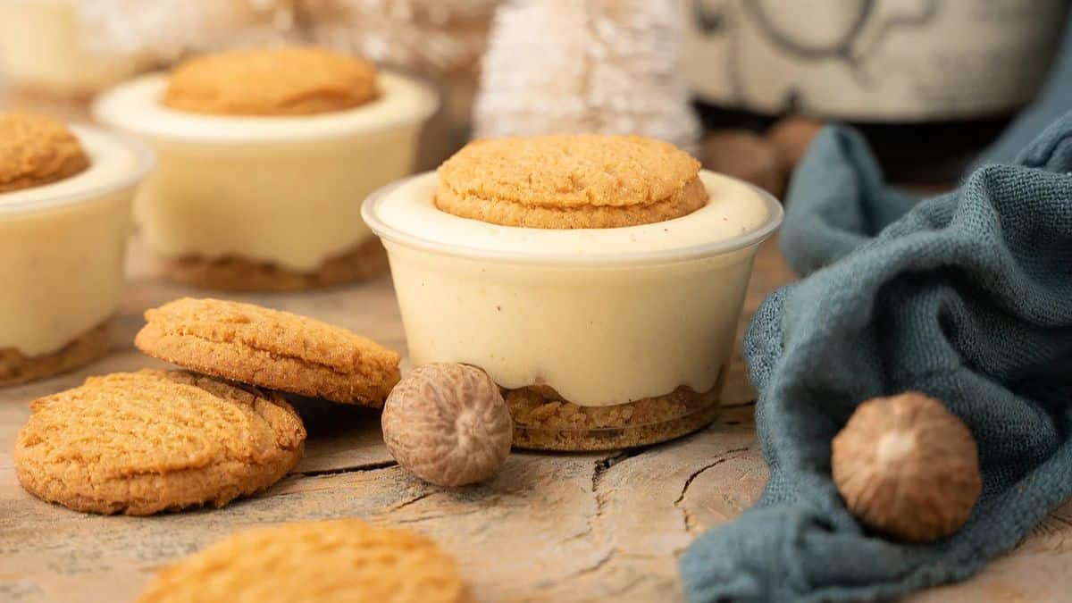Three servings of Ginger Snap Eggnog Pudding Shots, a few cookie pieces is found on the side. 