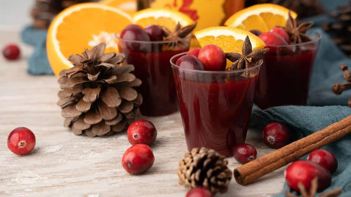 Three servings of Mulled Wine Fireball Jello Shots on a intricately decorated table. 