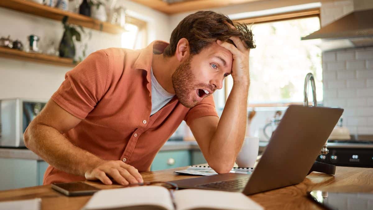 confused man looking at computer
